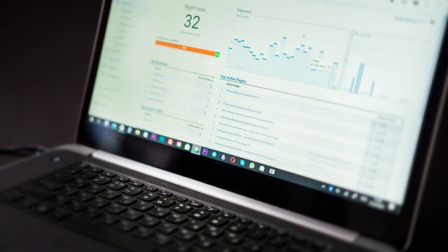 Laptop screen showing a web analytics dashboard with live visitor counts